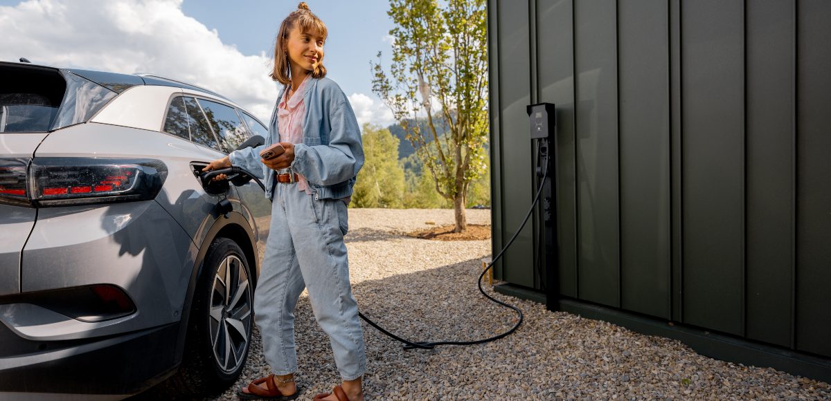 Niña cargando un coche eléctrico