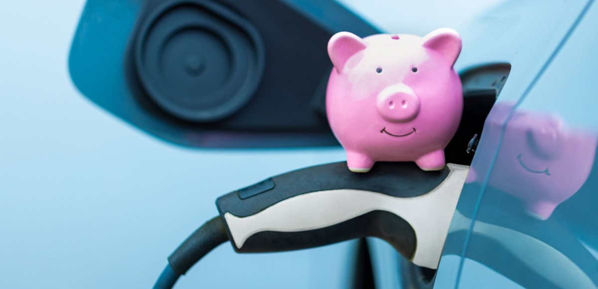 Car being charged with a charger and a piggy bank